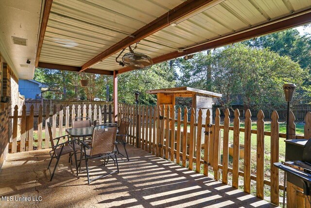 wooden terrace featuring a storage unit