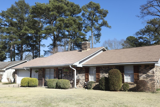 ranch-style house featuring a garage and a front lawn