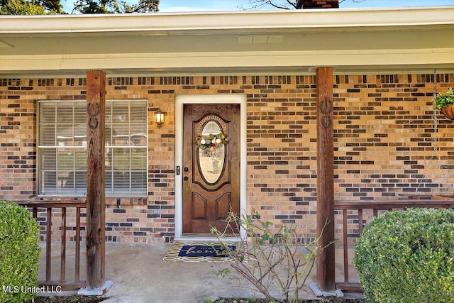 doorway to property featuring covered porch