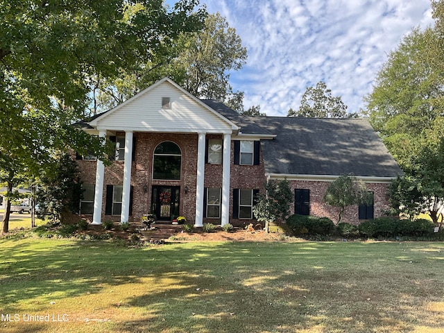 greek revival inspired property featuring a front yard