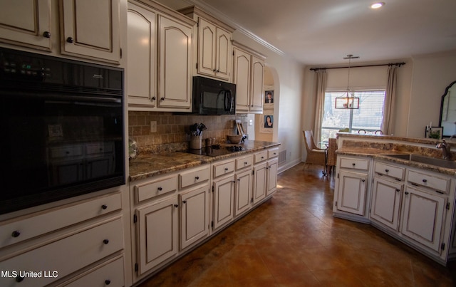 kitchen with decorative backsplash, sink, black appliances, pendant lighting, and a notable chandelier