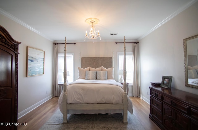 bedroom with light wood-type flooring, an inviting chandelier, multiple windows, and ornamental molding