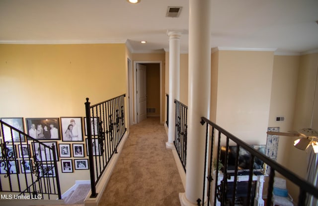 hall with light colored carpet, ornate columns, and crown molding