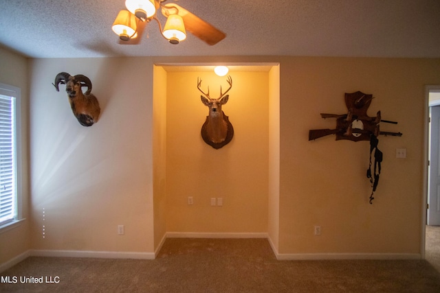 carpeted spare room with a textured ceiling