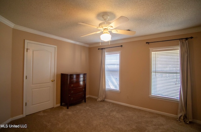 unfurnished bedroom featuring carpet flooring, ceiling fan, a textured ceiling, and ornamental molding