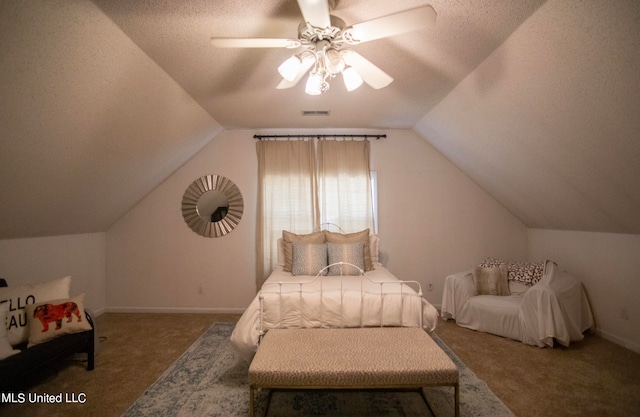 carpeted bedroom featuring a textured ceiling, ceiling fan, and lofted ceiling