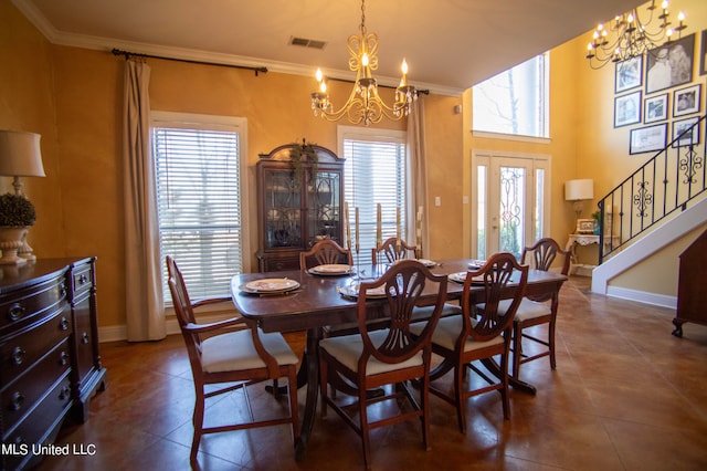 tiled dining area featuring a notable chandelier, a healthy amount of sunlight, and ornamental molding