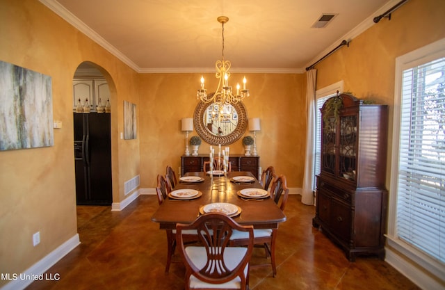 dining area featuring an inviting chandelier and crown molding