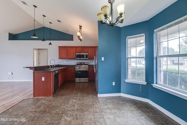 kitchen featuring a healthy amount of sunlight, appliances with stainless steel finishes, and decorative light fixtures