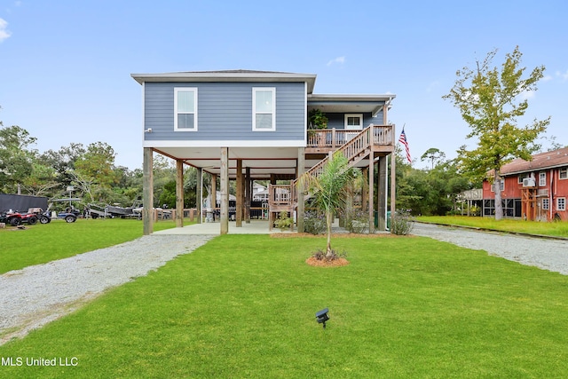 back of house featuring a lawn and a carport