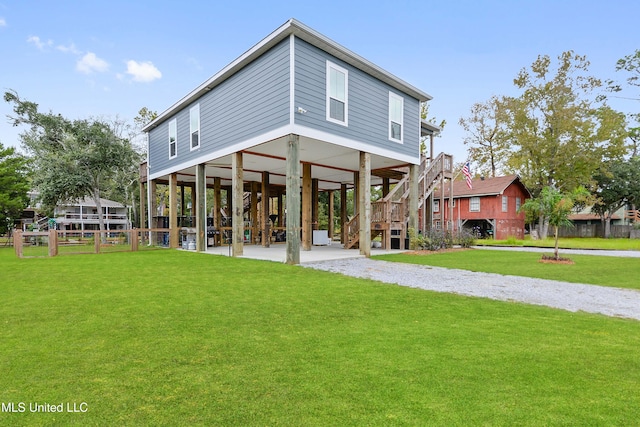 back of property with a patio area and a lawn