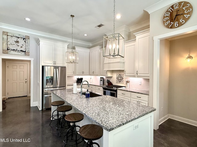 kitchen with appliances with stainless steel finishes, a sink, finished concrete floors, a chandelier, and crown molding