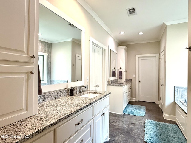 bathroom featuring two vanities, recessed lighting, ornamental molding, baseboards, and a bath