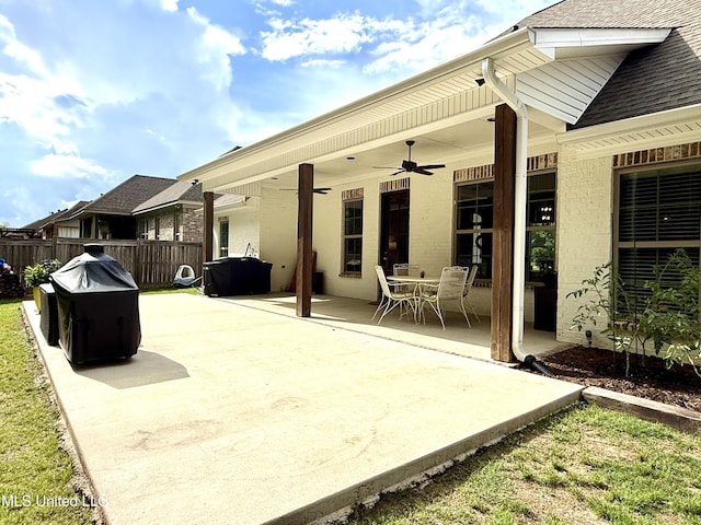 view of patio with a ceiling fan and fence