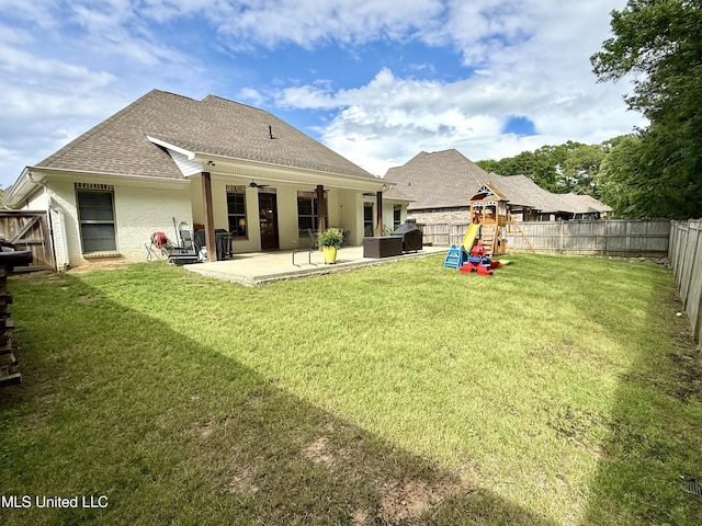 back of house featuring a playground, a patio, and roof with shingles