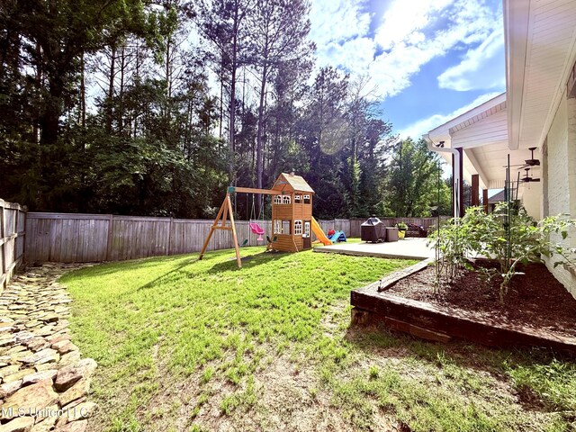 view of yard with a playground and a patio
