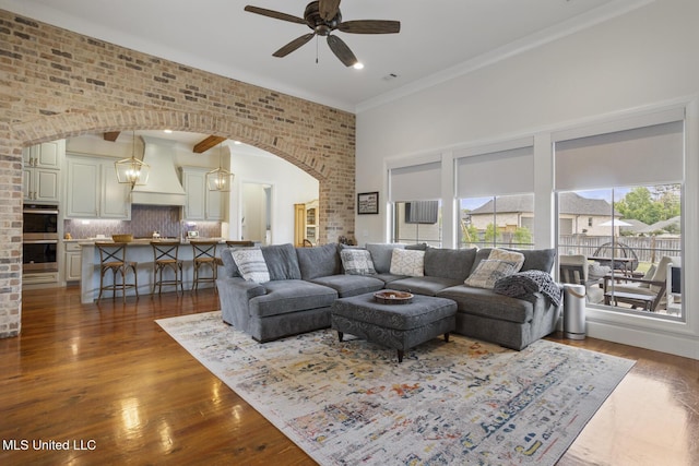 508 Forest Glen Ln, Brandon, MS 39047 - living area featuring arched walkways, ceiling fan, a high ceiling, wood finished floors, and ornamental molding