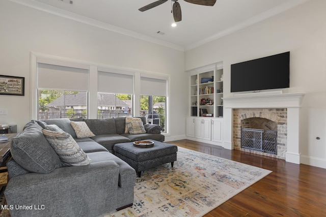 508 Forest Glen Ln, Brandon, MS 39047 - living area featuring a ceiling fan, crown molding, wood finished floors, built in shelves, and a fireplace