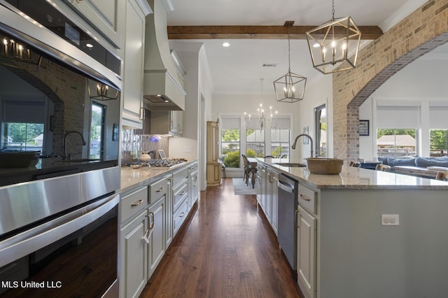 508 Forest Glen Ln, Brandon, MS 39047 - kitchen featuring a chandelier, appliances with stainless steel finishes, plenty of natural light, beam ceiling, and recessed lighting
