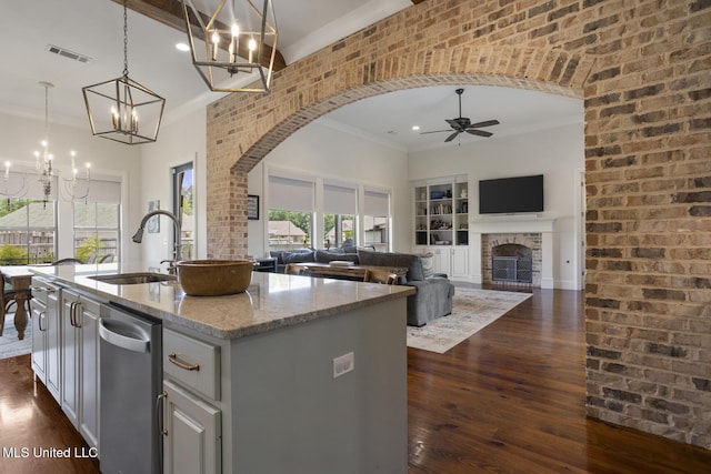 508 Forest Glen Ln, Brandon, MS 39047 - kitchen featuring a chandelier, arched walkways, ceiling fan, a fireplace, and crown molding