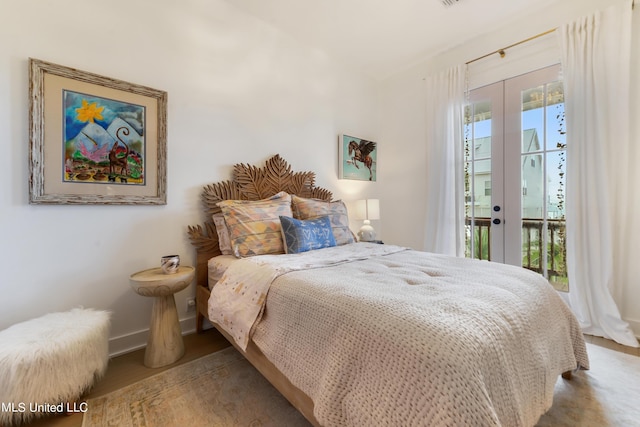 218 Front St, Pass Christian, MS 39571 - bedroom featuring access to exterior, french doors, baseboards, and wood finished floors