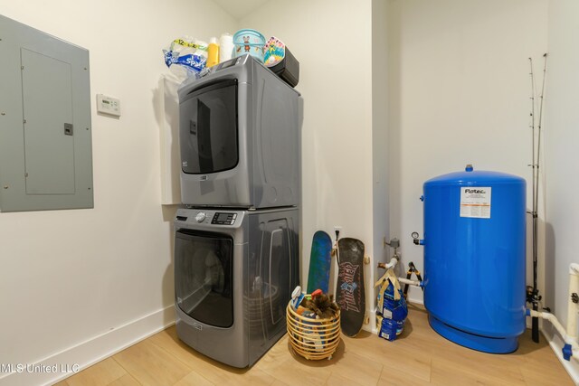 218 Front St, Pass Christian, MS 39571 - laundry room with electric panel, stacked washer / dryer, and wood finished floors