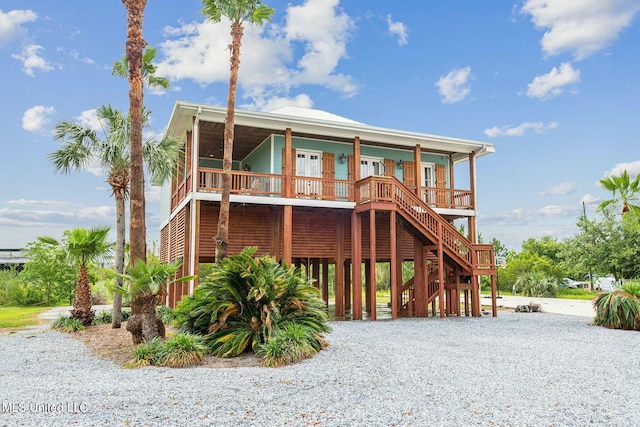 218 Front St, Pass Christian, MS 39571 - coastal inspired home with a porch, stairs, and a carport