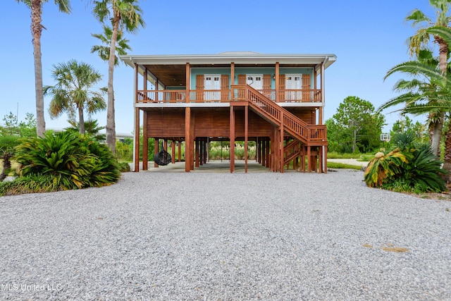 218 Front St, Pass Christian, MS 39571 - view of front of property featuring a carport, covered porch, stairs, and driveway
