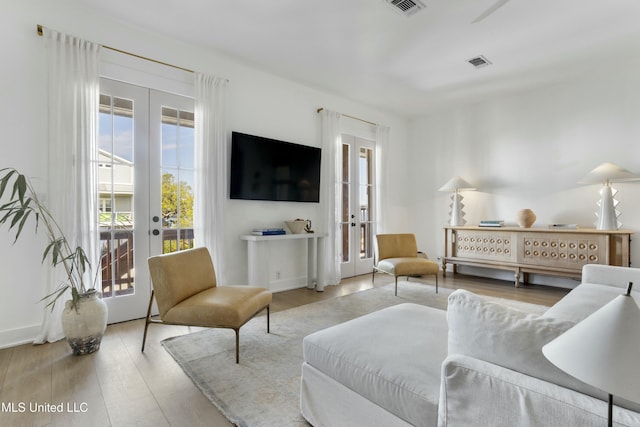 218 Front St, Pass Christian, MS 39571 - living area featuring french doors and wood finished floors