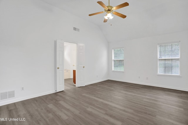 empty room with dark wood-type flooring, visible vents, baseboards, and a ceiling fan