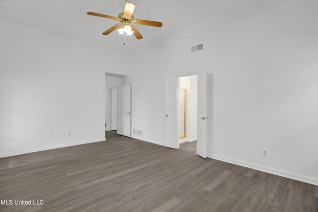 unfurnished bedroom featuring dark wood-style floors, baseboards, and visible vents