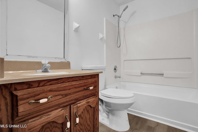 full bath featuring  shower combination, vanity, toilet, and wood finished floors