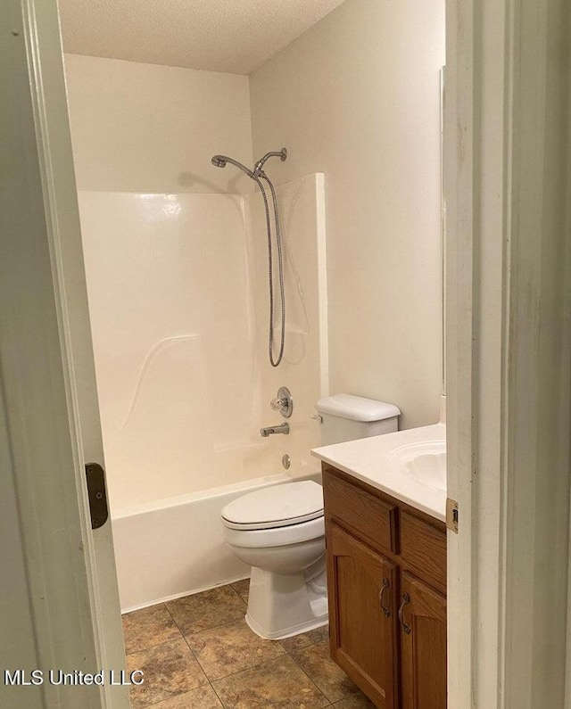 full bathroom with toilet, vanity, a textured ceiling, and tub / shower combination