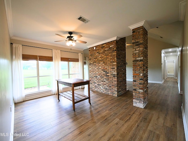 6936 Aulena Pl, Diamondhead, MS 39525 - unfurnished dining area with decorative columns, ceiling fan, ornamental molding, and wood finished floors