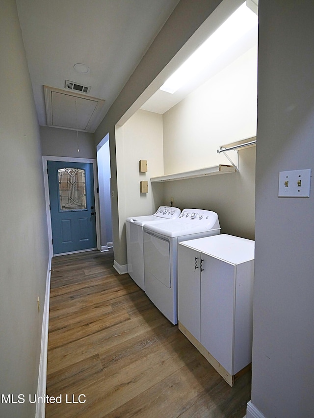 6936 Aulena Pl, Diamondhead, MS 39525 - washroom featuring separate washer and dryer, attic access, and wood finished floors