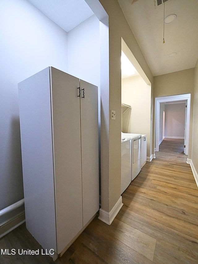 6936 Aulena Pl, Diamondhead, MS 39525 - hallway with washer and clothes dryer and wood finished floors