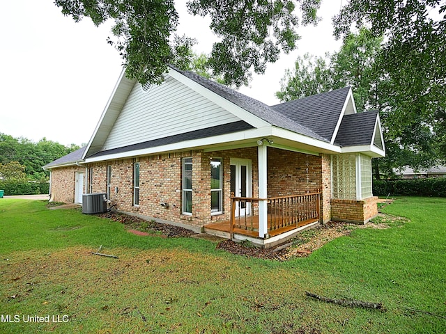 6936 Aulena Pl, Diamondhead, MS 39525 - view of side of home featuring brick siding, a lawn, a porch, and a shingled roof