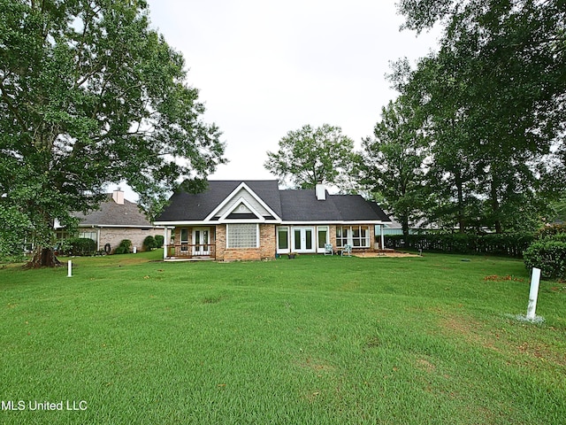 6936 Aulena Pl, Diamondhead, MS 39525 - view of front of house featuring french doors, a front yard, and brick siding