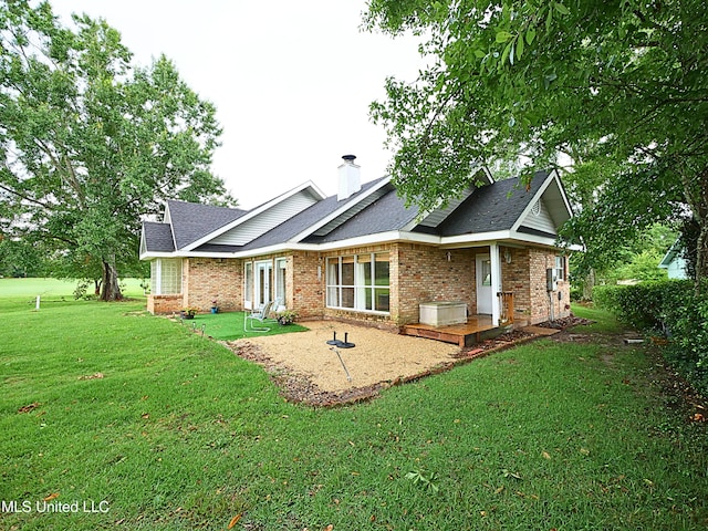 6936 Aulena Pl, Diamondhead, MS 39525 - back of property with brick siding, a lawn, roof with shingles, and a chimney