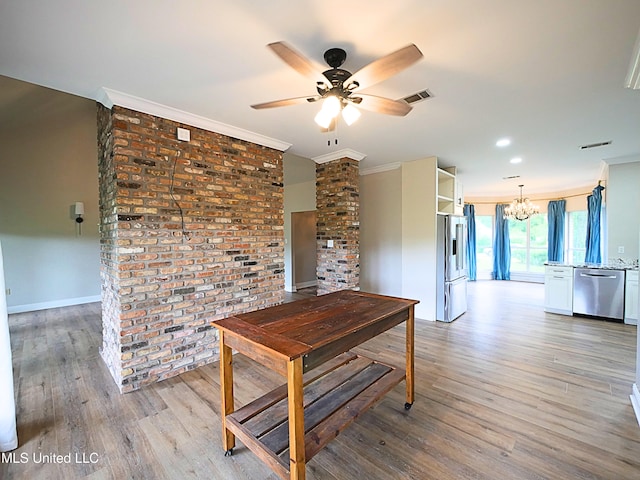 6936 Aulena Pl, Diamondhead, MS 39525 - dining area featuring crown molding, a chandelier, light wood-style floors, and ceiling fan