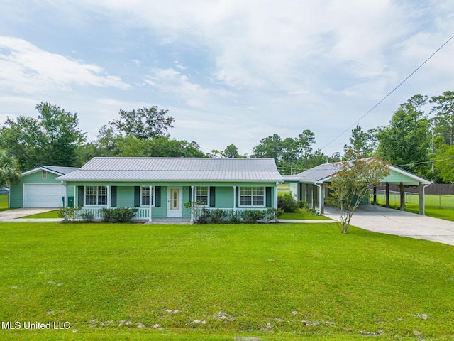 1025 Shipp St, Waveland, MS 39576 - ranch-style house with a porch, driveway, a front lawn, a detached carport, and metal roof