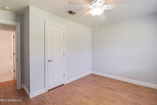 1025 Shipp St, Waveland, MS 39576 - unfurnished bedroom with light wood-style floors, baseboards, and a ceiling fan