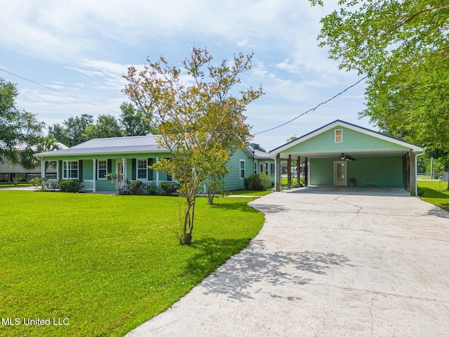 1025 Shipp St, Waveland, MS 39576 - single story home featuring a porch, a front yard, driveway, ceiling fan, and a carport