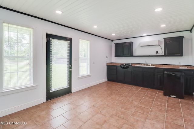 1025 Shipp St, Waveland, MS 39576 - kitchen featuring black dishwasher, a sink, healthy amount of natural light, a wall unit AC, and recessed lighting