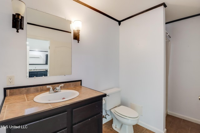 1025 Shipp St, Waveland, MS 39576 - bathroom featuring toilet, vanity, tile patterned floors, ornamental molding, and baseboards