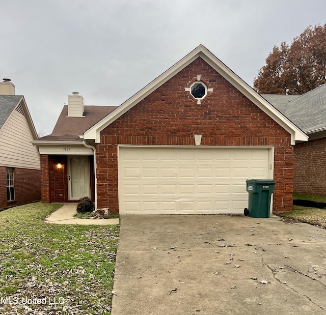 7827 S Chesterfield Dr, Southaven, MS 38671 - view of front of property featuring brick siding, concrete driveway, a chimney, roof with shingles, and a garage