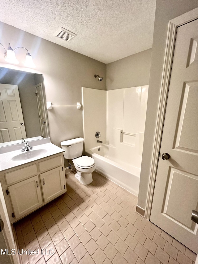 7827 S Chesterfield Dr, Southaven, MS 38671 - bathroom with shower / bathtub combination, vanity, toilet, a textured ceiling, and baseboards