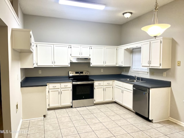 7827 S Chesterfield Dr, Southaven, MS 38671 - kitchen with stainless steel appliances, under cabinet range hood, a sink, dark countertops, and light tile patterned floors