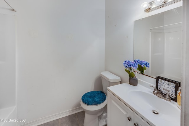 bathroom featuring vanity, toilet, a shower, and tile patterned flooring