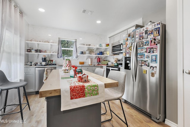 13701 Jericho Rd, Vancleave, MS 39565 - kitchen featuring stainless steel appliances, gray cabinetry, and open shelves